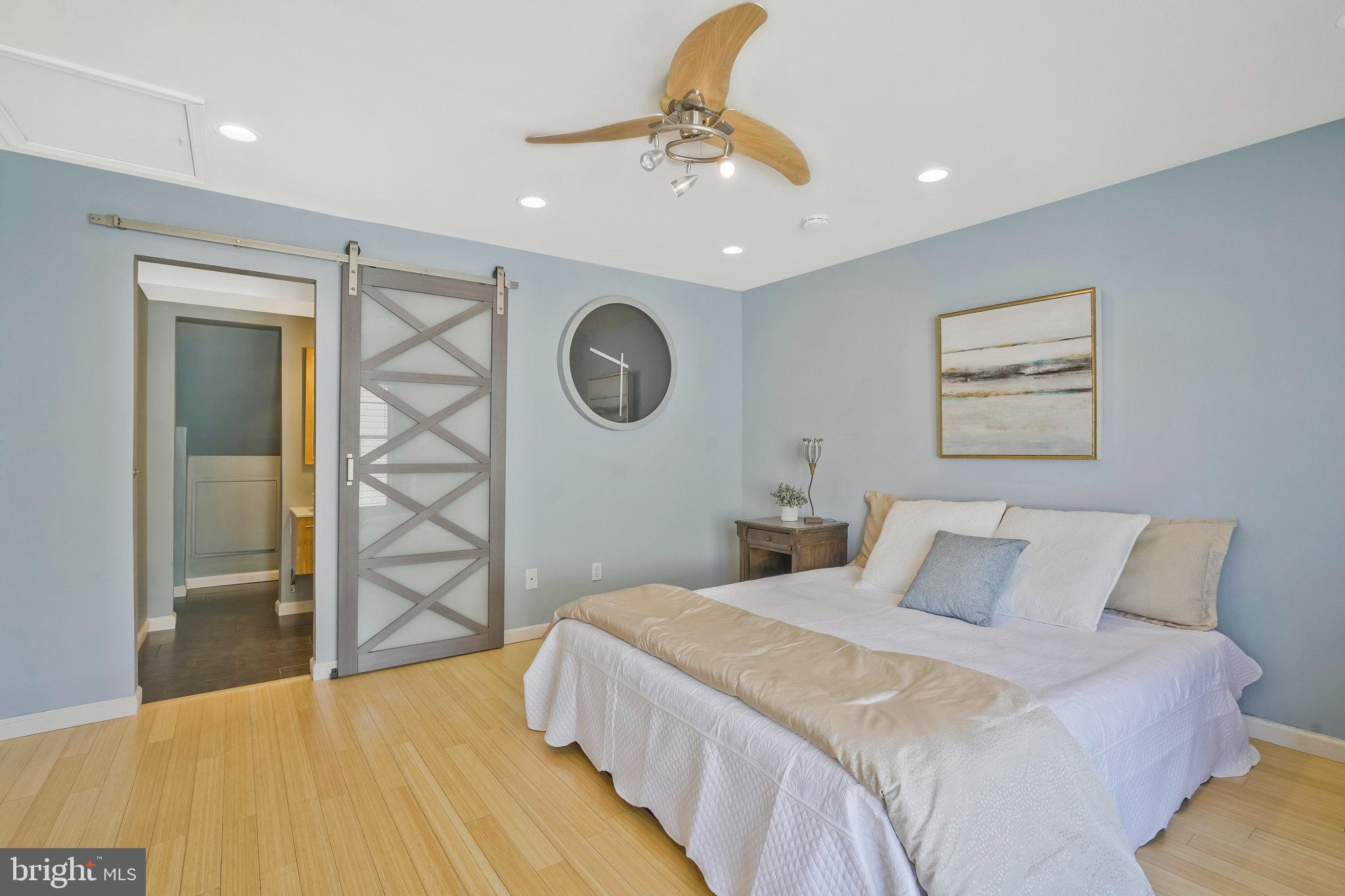 2181 Shirlington Road Arlington, VA 22206 - Photo 25 of 48 a bedroom with a bed and a chandelier