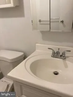 a bathroom with a toilet and a sink