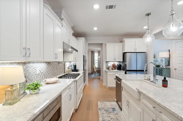 a large kitchen with stainless steel appliances kitchen island granite countertop a sink and cabinets