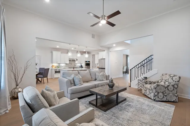 a living room with furniture and a chandelier