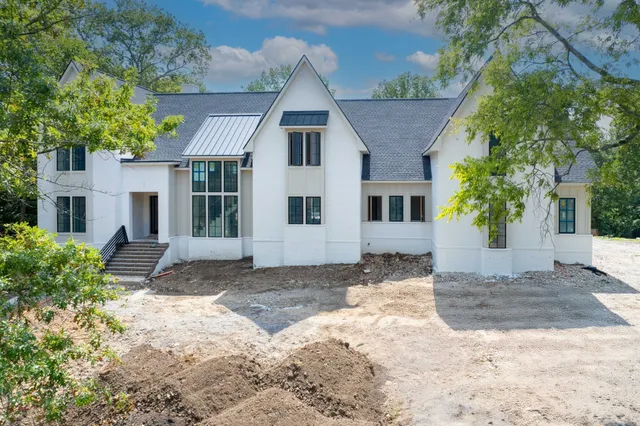 a view of a grey house with a yard