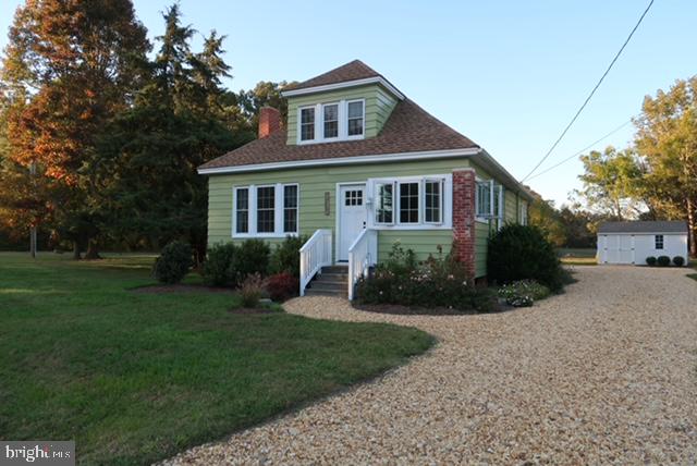 27209 Saxis Road Temperanceville, VA 23442 - Photo 1 of 31 a front view of a house with a yard
