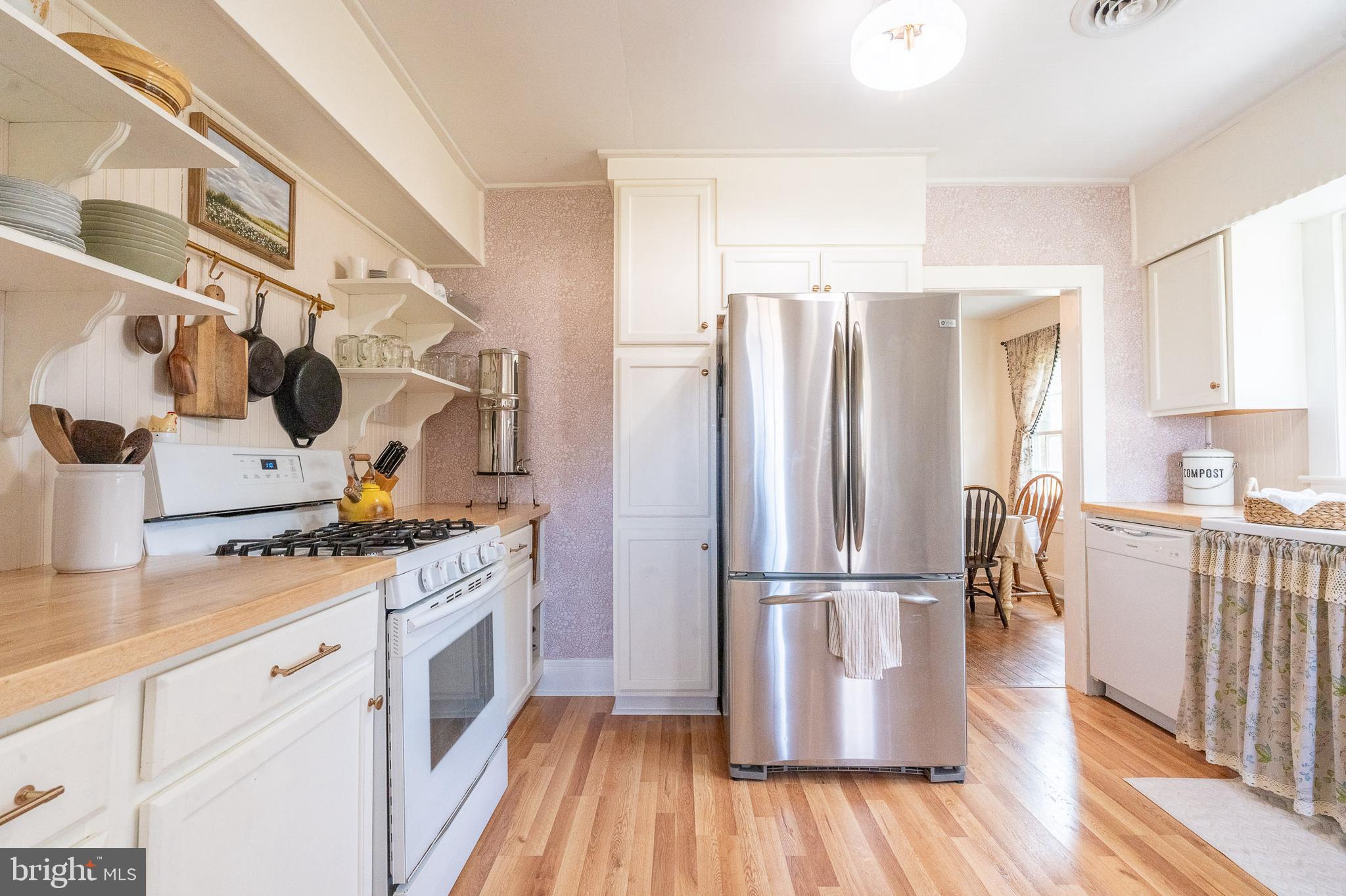 27209 Saxis Road Temperanceville, VA 23442 - Photo 19 of 31 a kitchen with stainless steel appliances granite countertop a refrigerator stove and wooden floor