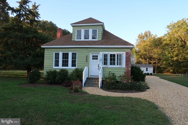27209 Saxis Road Temperanceville, VA 23442 - Photo 2 of 31 a front view of a house with a yard