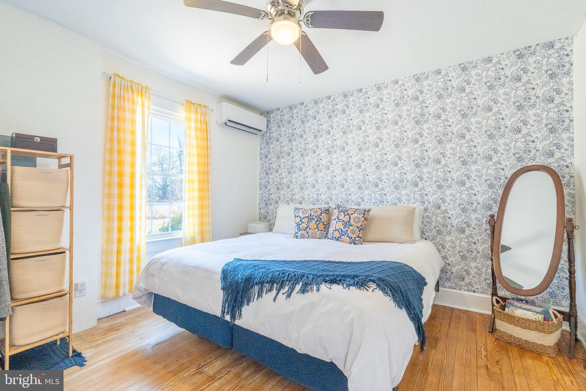 27209 Saxis Road Temperanceville, VA 23442 - Photo 23 of 31 a bedroom with a bed and a chandelier