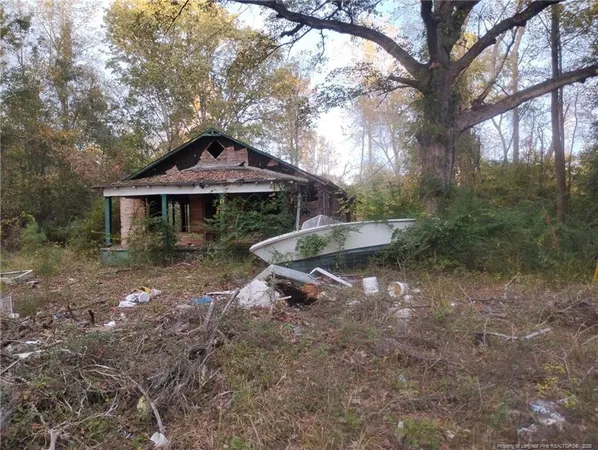 a backyard of a house with table and chairs