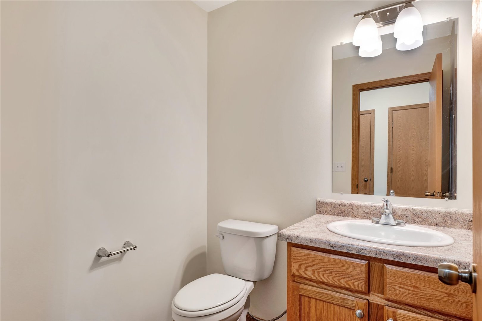 3315 Boulder Ridge Drive Champaign, IL 61822 - Photo 5 of 8 a bathroom with a granite countertop sink toilet and a mirror