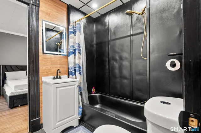 a bedroom with a bed and wooden floor