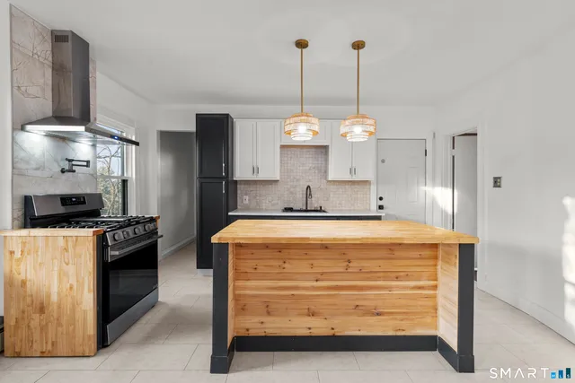 a view of a kitchen with stainless steel appliances granite countertop cabinets and a wooden floor