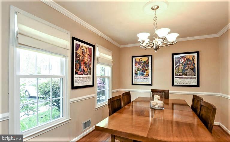2406 Wanda Way Reston, VA 20191 - Photo 3 of 30 a view of a dining room with furniture a chandelier and wooden floor