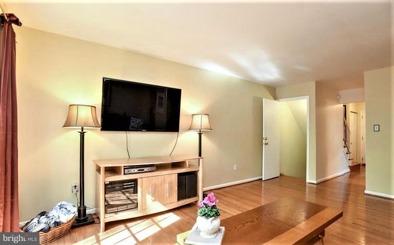 2406 Wanda Way Reston, VA 20191 - Photo 8 of 30 a living room with a flat screen tv and kitchen view