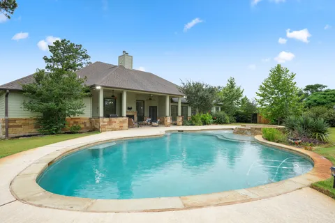 a outdoor space with patio furniture and a lake view