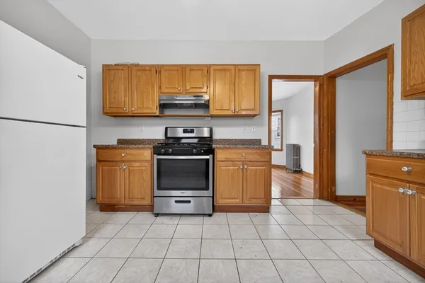 a kitchen with a sink a stove and a refrigerator