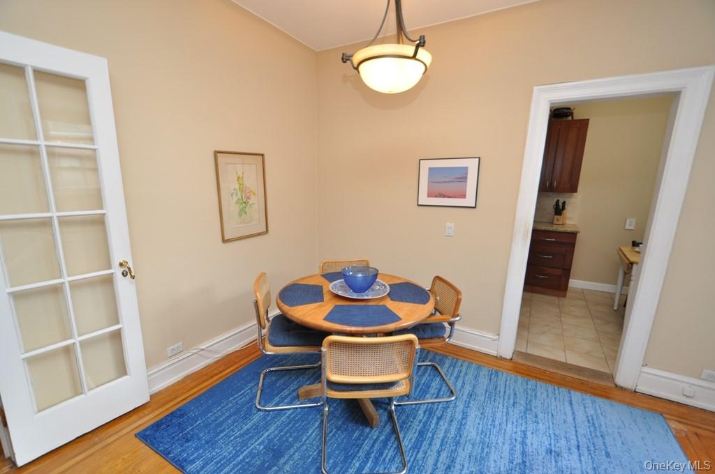 143 Garth Road, Unit 5J Scarsdale, NY 10583 - Photo 17 of 47 a view of a dining room with furniture and wooden floor