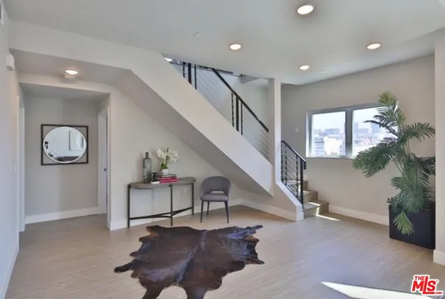 a living room with furniture and a stairs