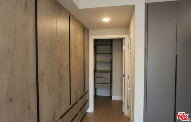 a view of a hallway with a wooden door