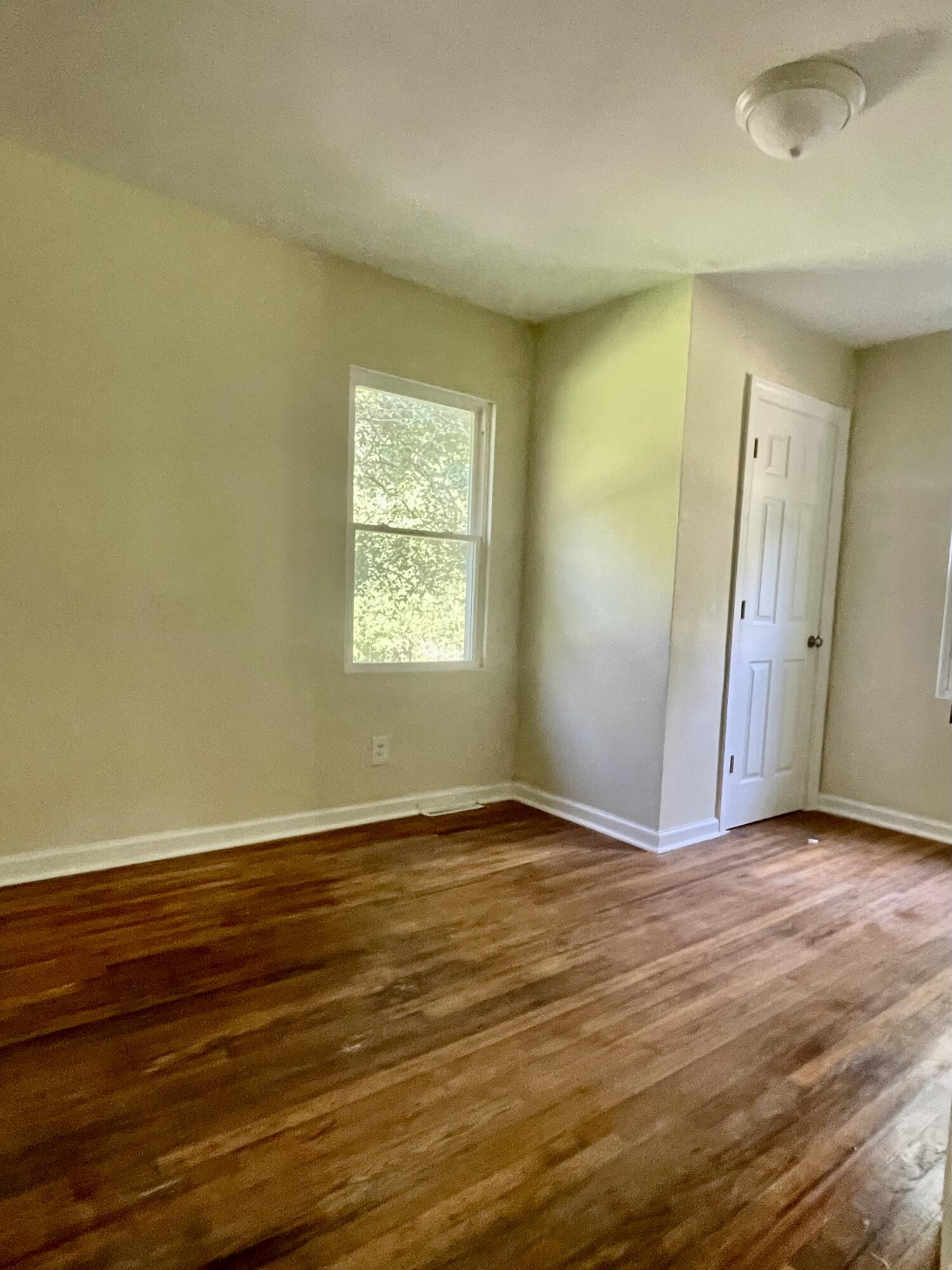 425 Rosa Hill Street Edgefield, SC 29824 - Photo 10 of 14 an empty room with wooden floor and windows
