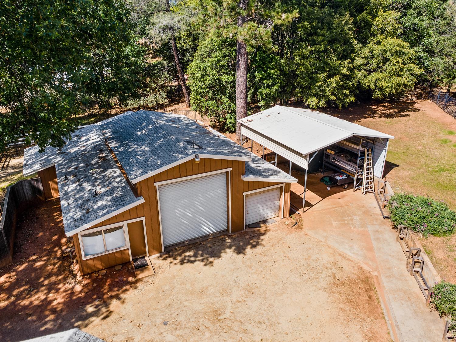 6460 Claim Street Placerville, CA 95667 - Photo 21 of 86 a view of a wooden house with a yard and large trees