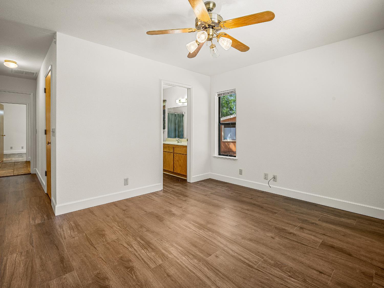 6460 Claim Street Placerville, CA 95667 - Photo 34 of 86 an empty room with wooden floor chandelier fan and windows