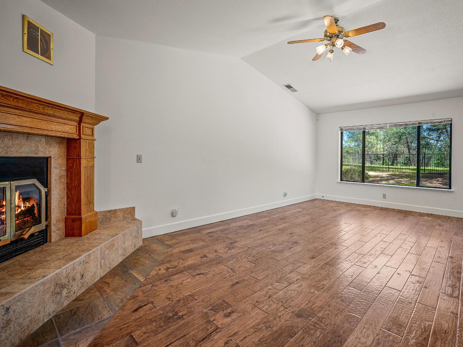 6460 Claim Street Placerville, CA 95667 - Photo 44 of 86 a view of a livingroom with a fireplace a ceiling fan and wooden floor