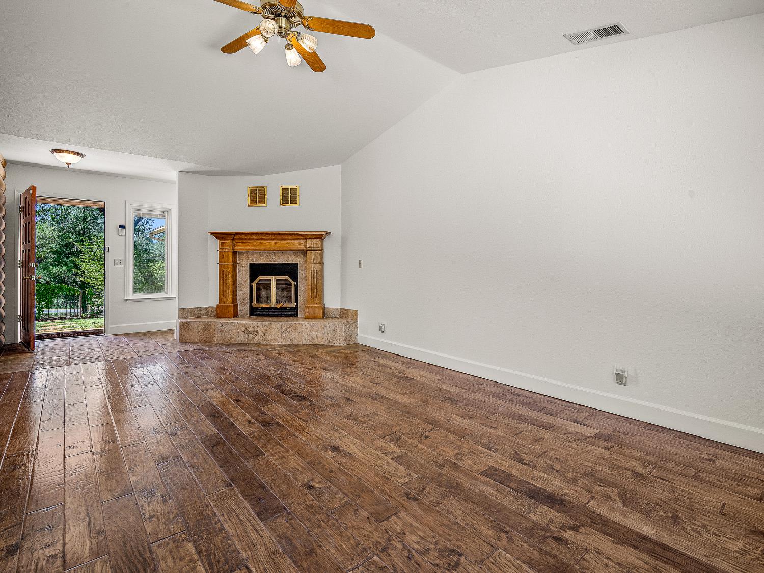 6460 Claim Street Placerville, CA 95667 - Photo 45 of 86 wooden floor fireplace and windows in an empty room