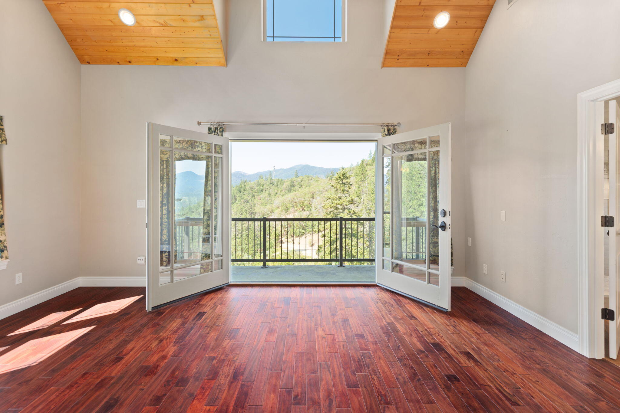 7304 North Applegate Road Grants Pass, OR 97527 - Photo 29 of 87 a view of an empty room with wooden floor and a window