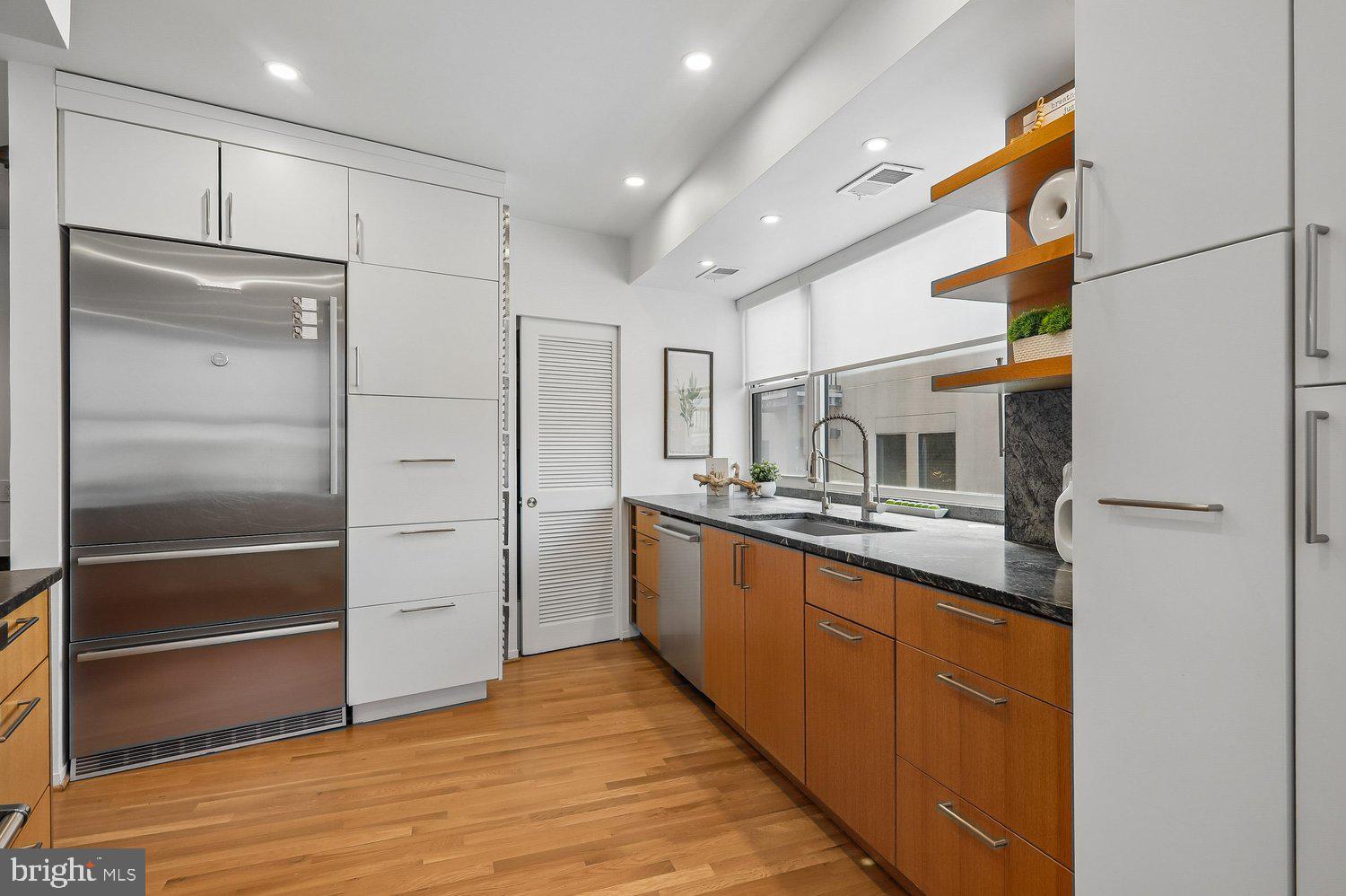 2370 Champlain Street Northwest, Unit 35 Washington, DC 20009 - Photo 13 of 49 a kitchen with stainless steel appliances granite countertop a refrigerator and a sink