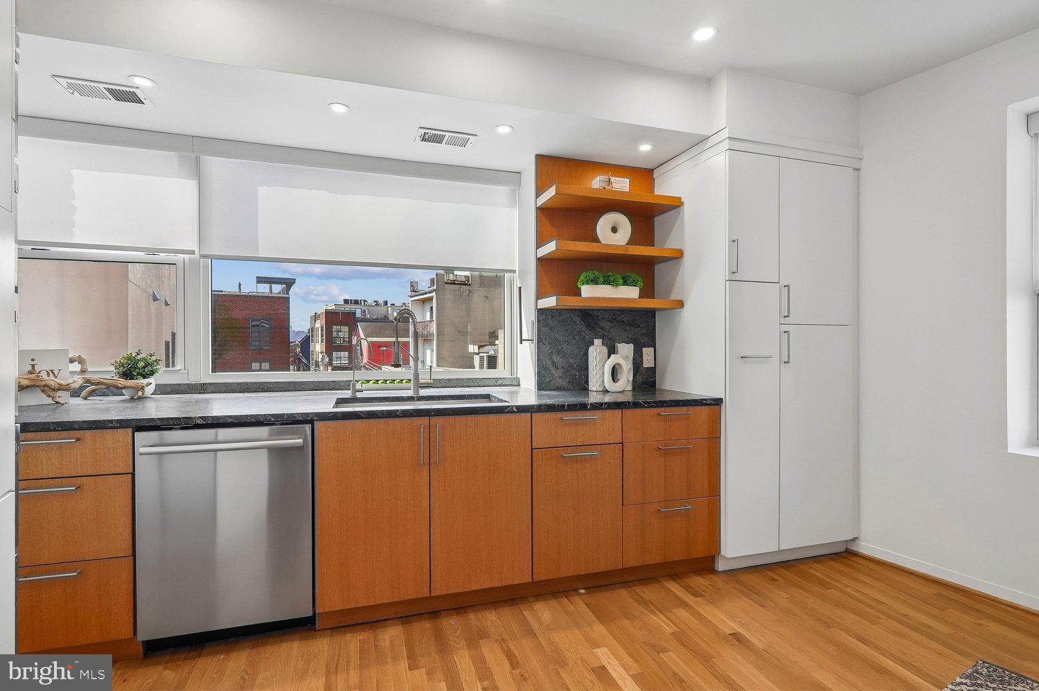 2370 Champlain Street Northwest, Unit 35 Washington, DC 20009 - Photo 15 of 49 a kitchen with stainless steel appliances granite countertop a sink and a microwave