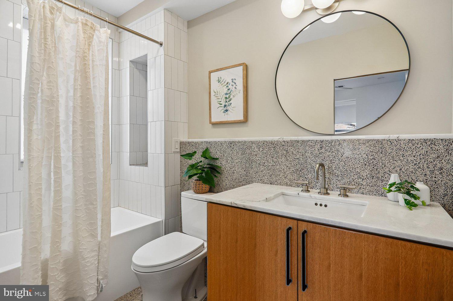 2370 Champlain Street Northwest, Unit 35 Washington, DC 20009 - Photo 18 of 49 a bathroom with a sink a mirror a toilet and a window