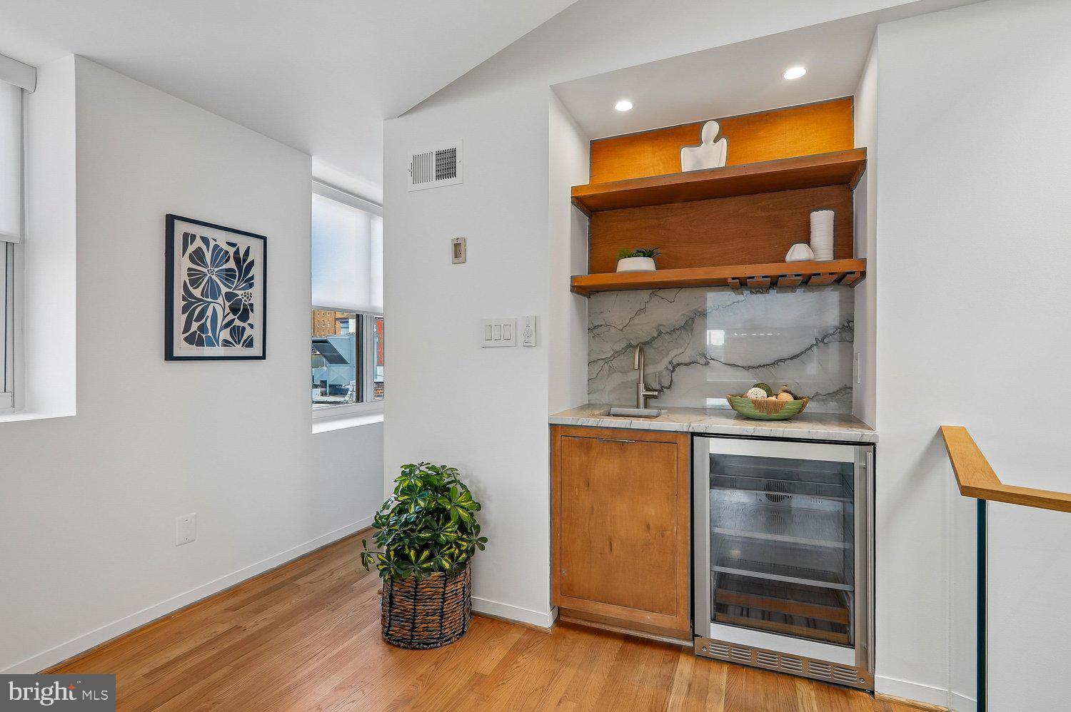 2370 Champlain Street Northwest, Unit 35 Washington, DC 20009 - Photo 22 of 49 a room with wooden floor and mirror
