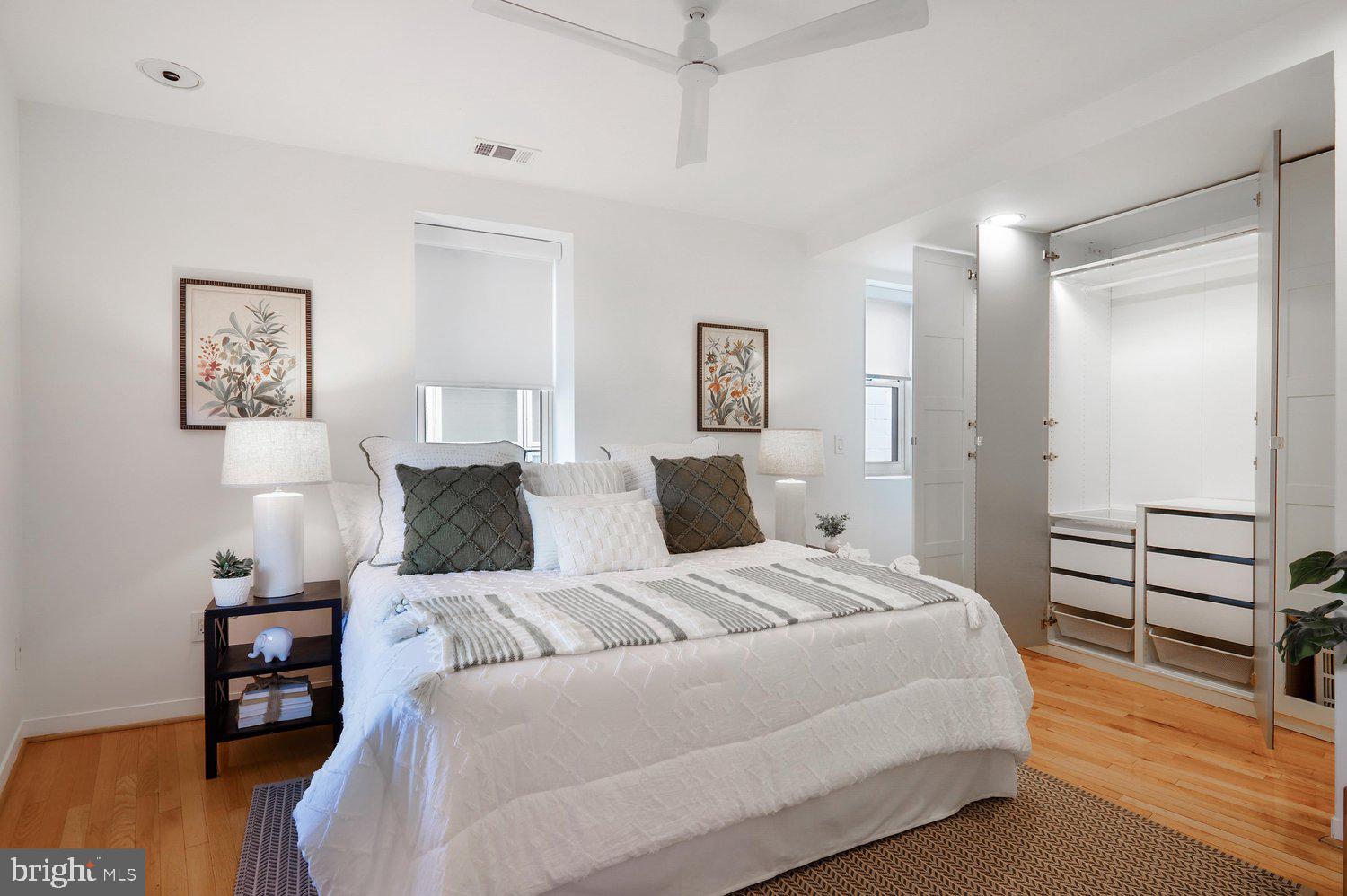 2370 Champlain Street Northwest, Unit 35 Washington, DC 20009 - Photo 26 of 49 a bedroom with a bed and wooden floor