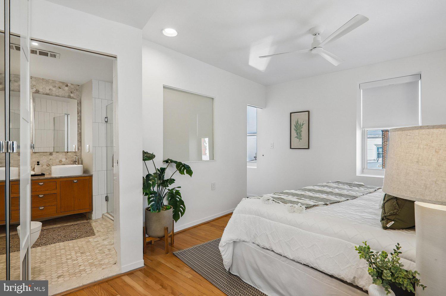 2370 Champlain Street Northwest, Unit 35 Washington, DC 20009 - Photo 27 of 49 a bedroom with a bed and a potted plant