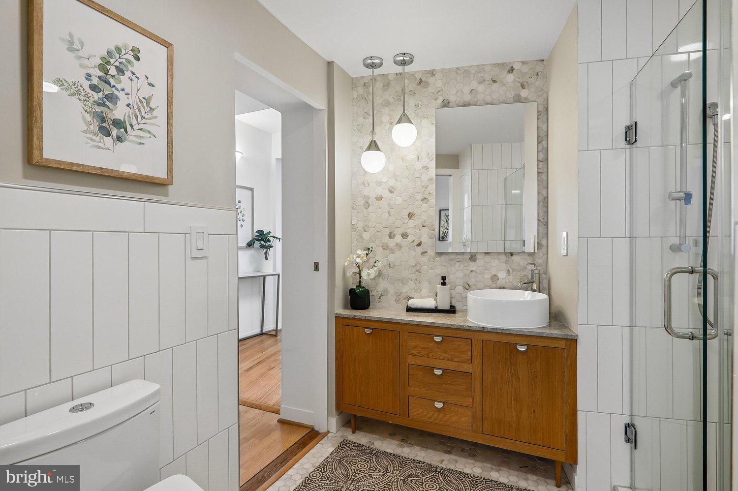 2370 Champlain Street Northwest, Unit 35 Washington, DC 20009 - Photo 32 of 49 a bathroom with a double vanity sink mirror and toilet