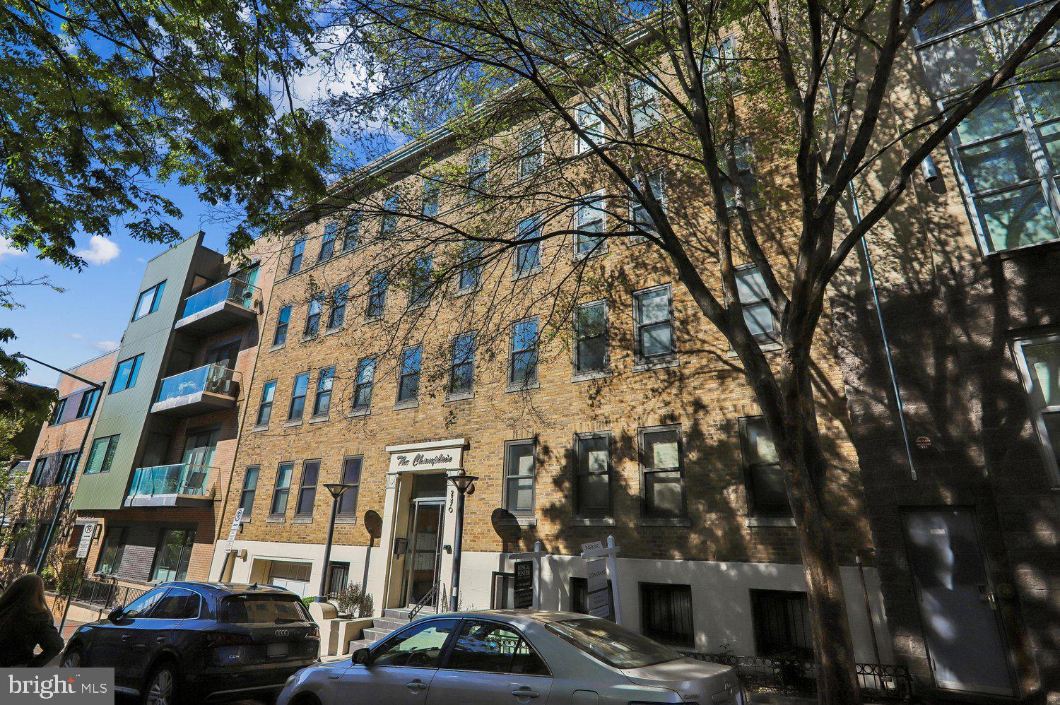 2370 Champlain Street Northwest, Unit 35 Washington, DC 20009 - Photo 35 of 49 a front view of a building with lot of cars and trees