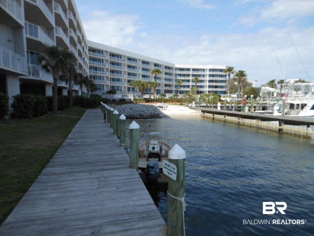 27800 Canal Road, Unit 214 Orange Beach, AL 36561 - Photo 3 of 6 1st come boat dock and sandy beach for kayaks.