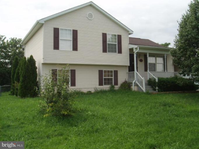 89 Cottontail Court Ranson, WV 25438 - Photo 1 of 9 a front view of a house with a garden