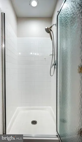 a bathroom with a glass shower door