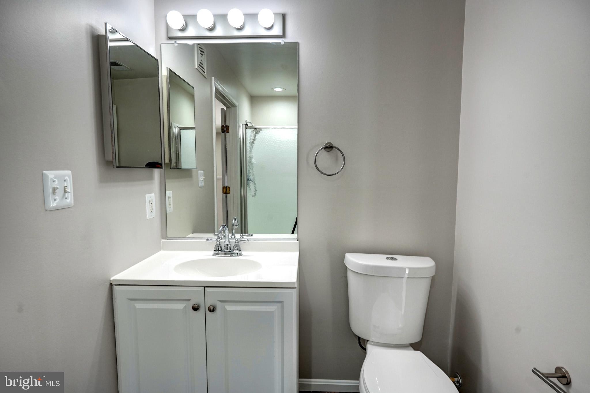 1001 Gaither Road, Unit I Rockville, MD 20850 - Photo 13 of 34 a bathroom with a toilet sink and mirror