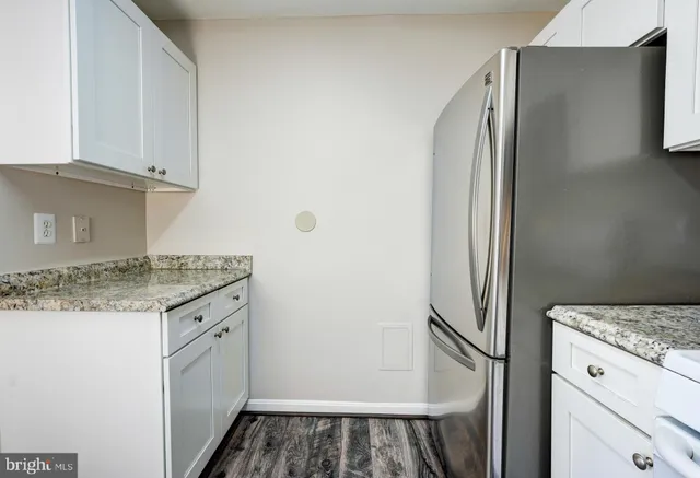 a kitchen with stainless steel appliances granite countertop a refrigerator and a stove