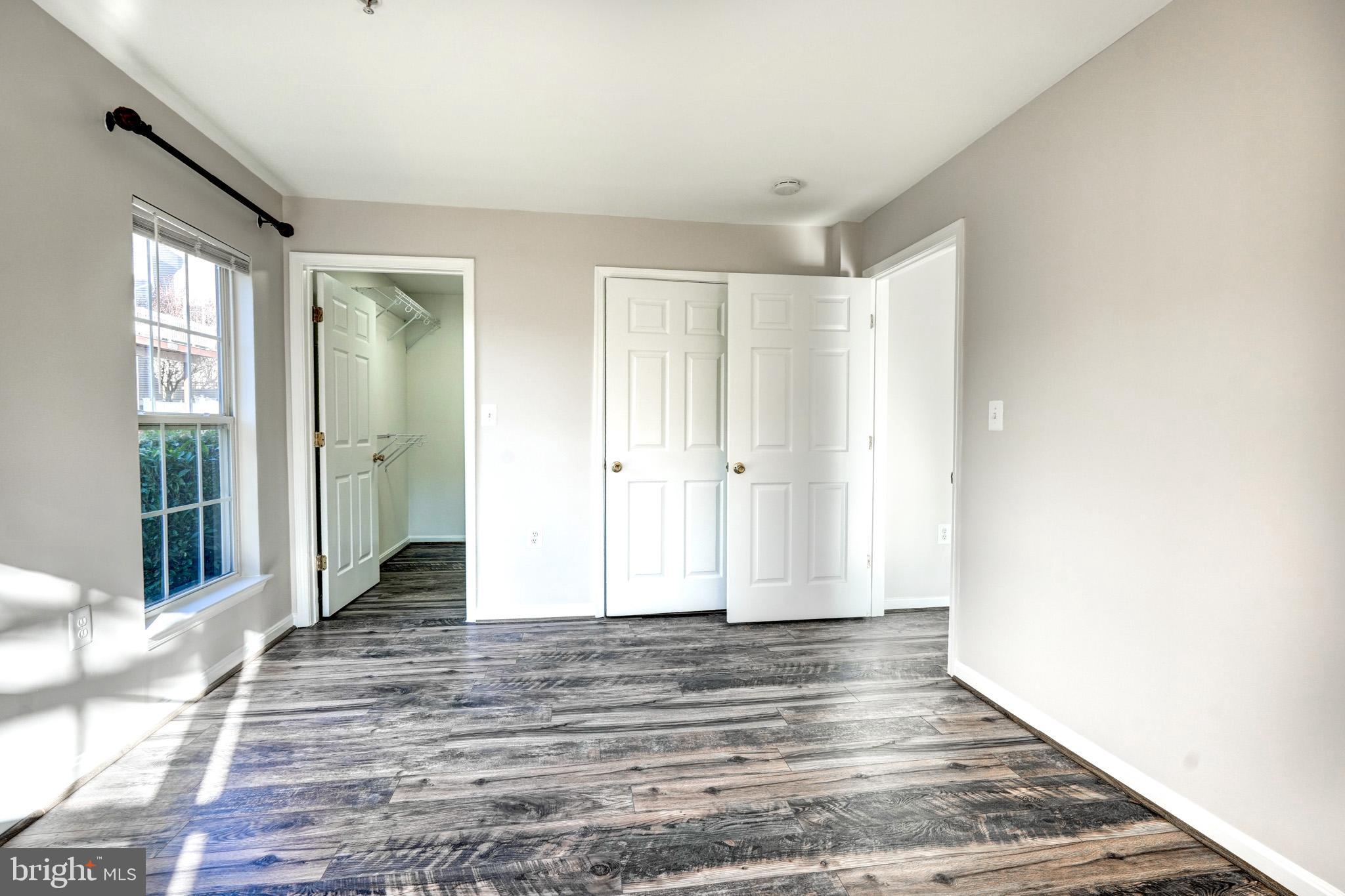 1001 Gaither Road, Unit I Rockville, MD 20850 - Photo 20 of 34 a view of a room with wooden floor and window