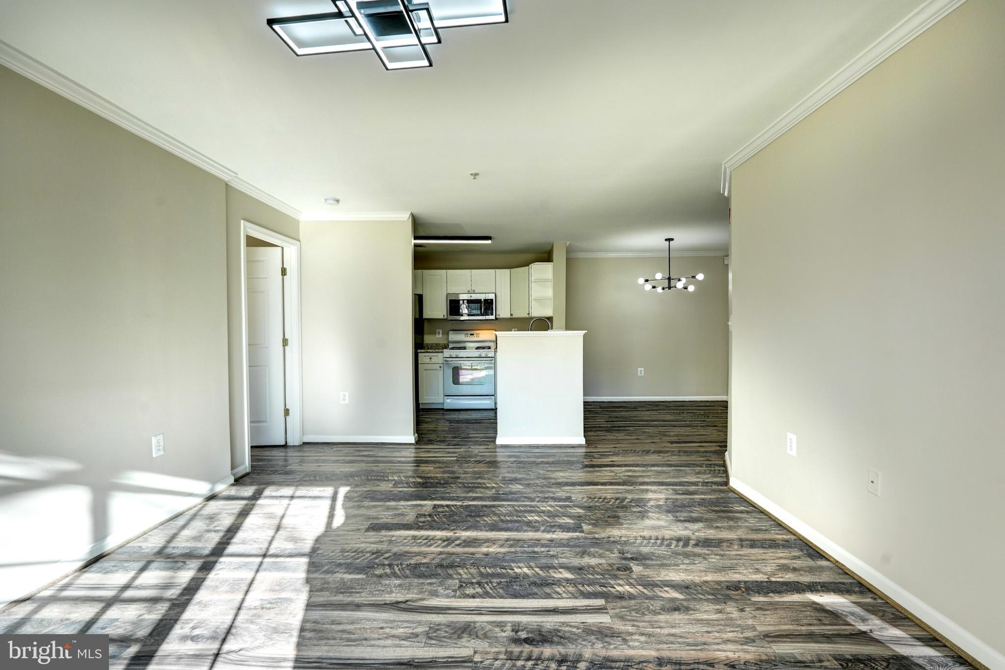 1001 Gaither Road, Unit I Rockville, MD 20850 - Photo 28 of 34 a view of a kitchen with wooden floor and a refrigerator
