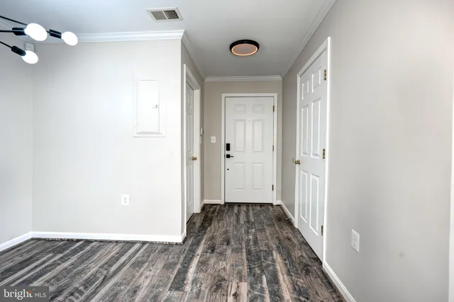 a view of a hallway with wooden floor