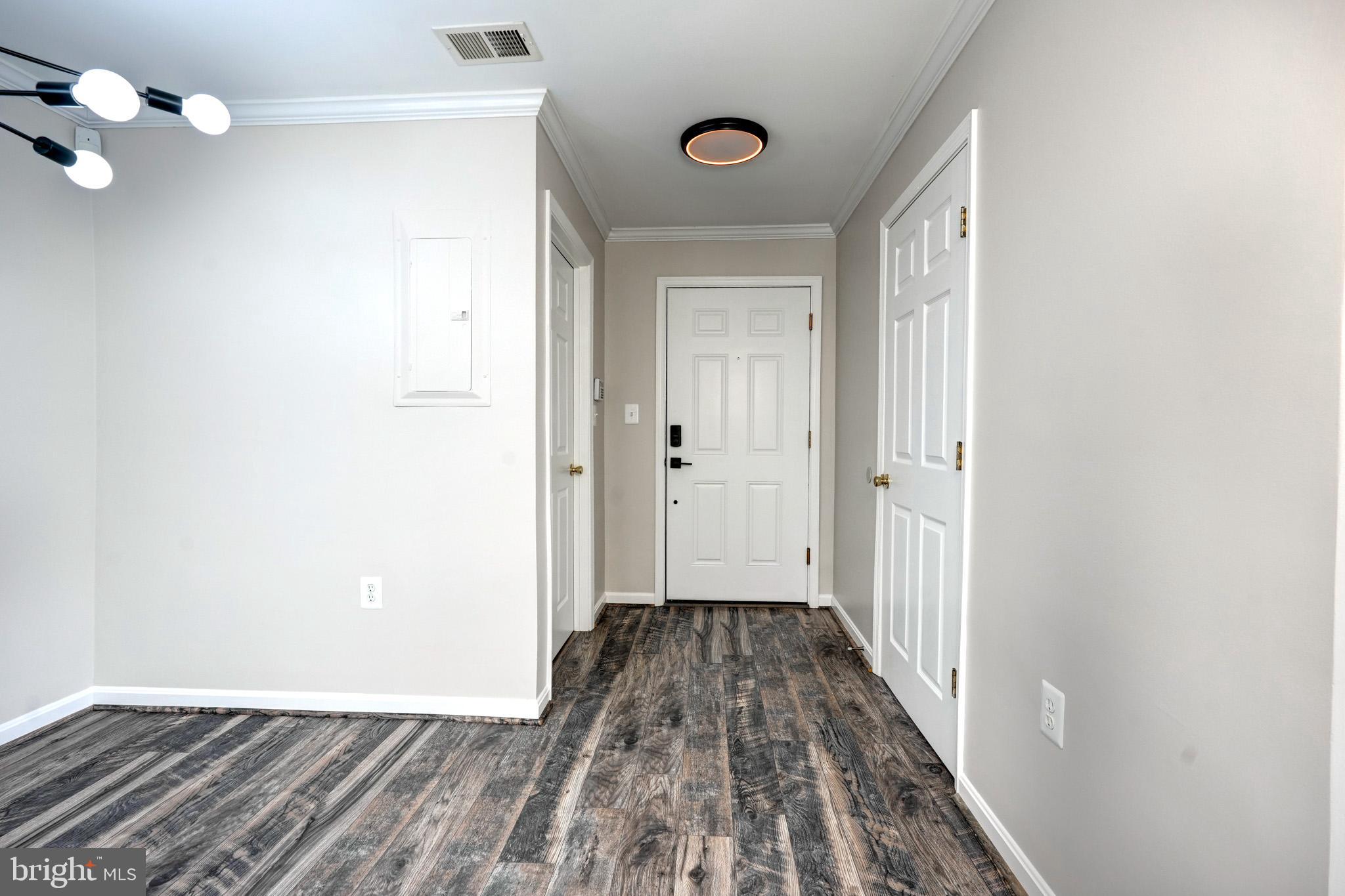 1001 Gaither Road, Unit I Rockville, MD 20850 - Photo 3 of 34 a view of a hallway with wooden floor