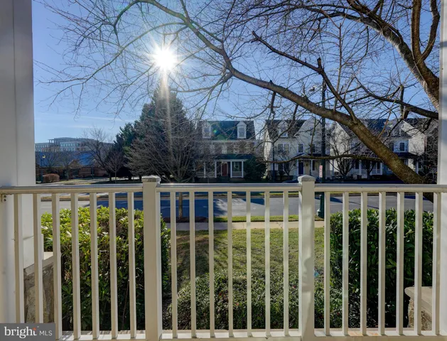 a view of a brick house with a large trees