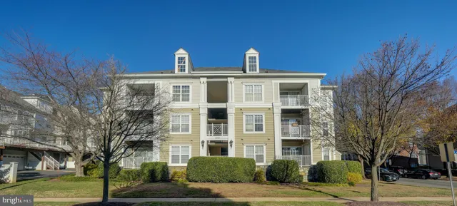 a front view of a building with a yard