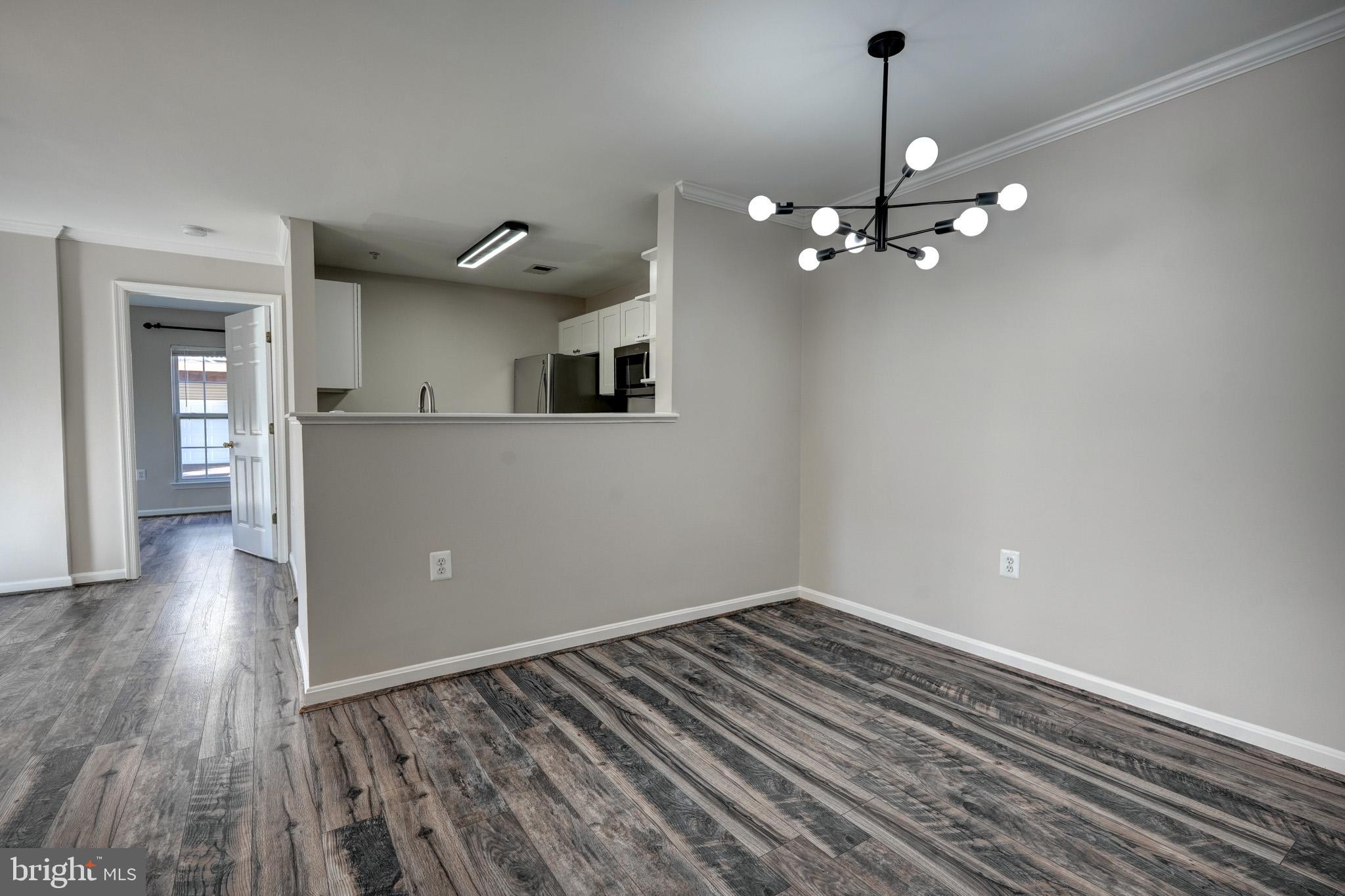 1001 Gaither Road, Unit I Rockville, MD 20850 - Photo 5 of 34 a view of empty room with wooden floor and ceiling fan