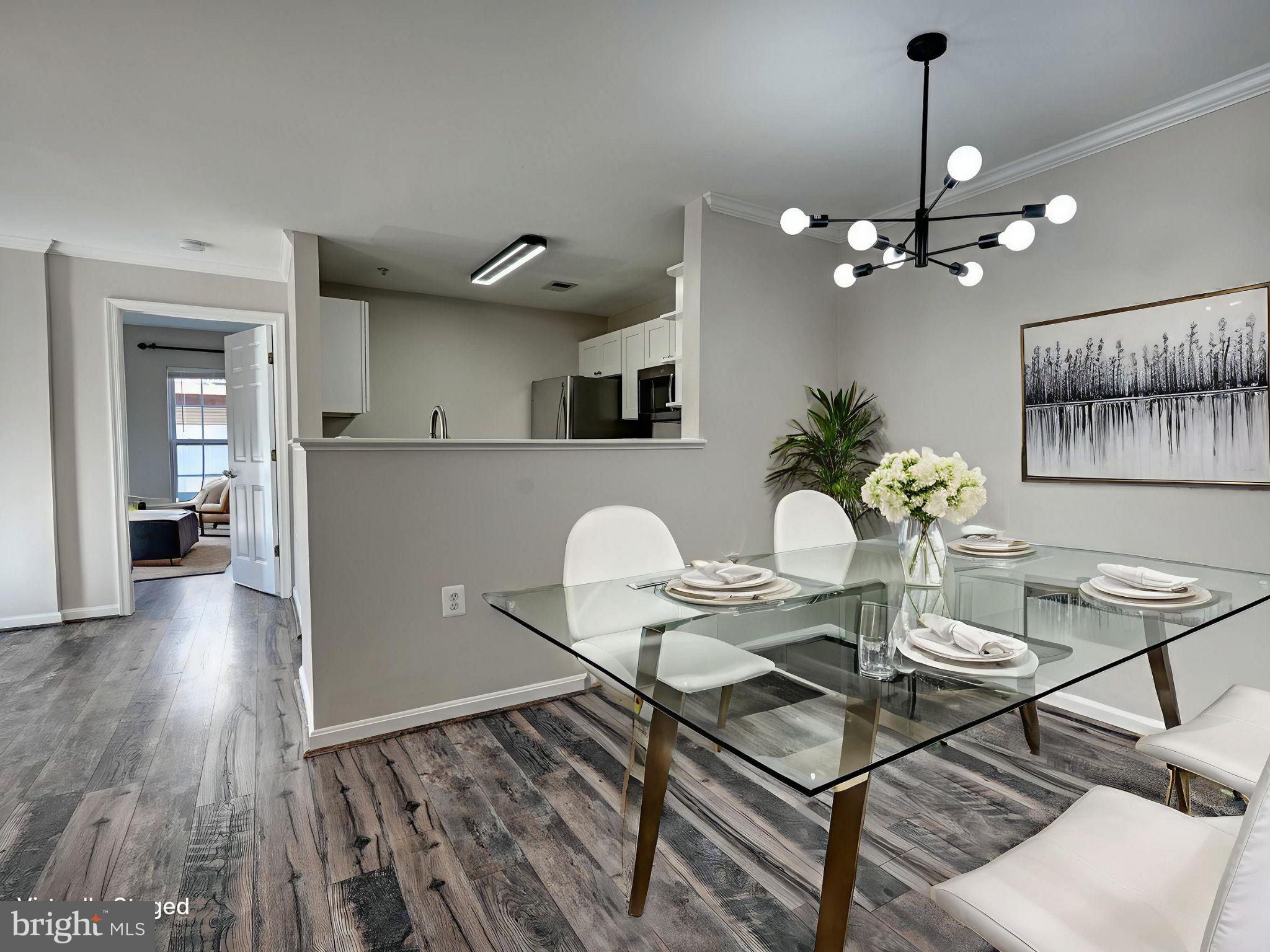 1001 Gaither Road, Unit I Rockville, MD 20850 - Photo 6 of 34 a view of a dining room with furniture and wooden floor
