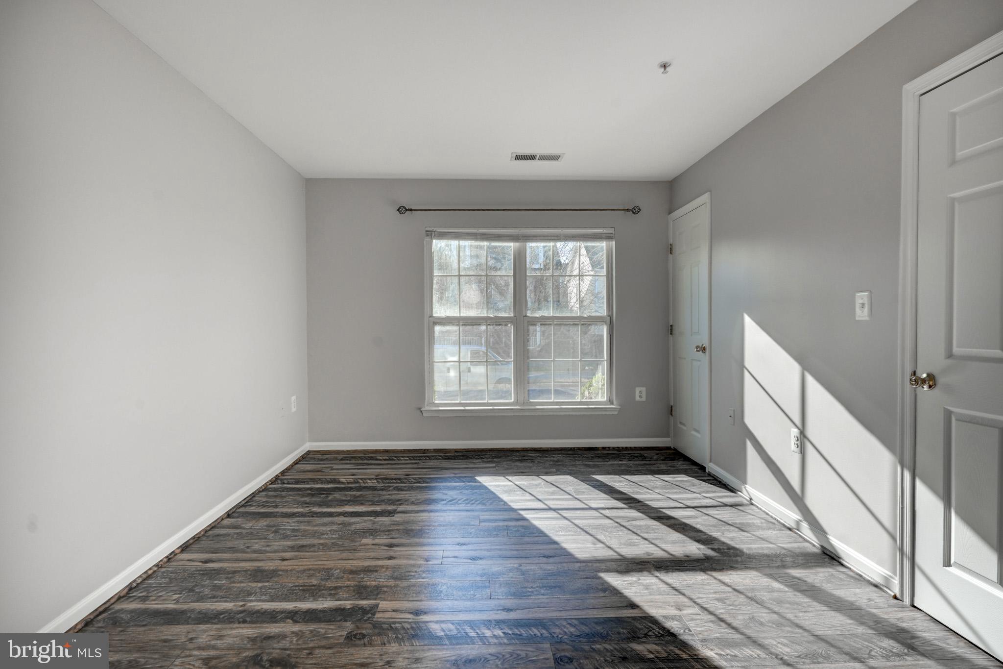 1001 Gaither Road, Unit I Rockville, MD 20850 - Photo 9 of 34 a view of empty room with wooden floor and fan