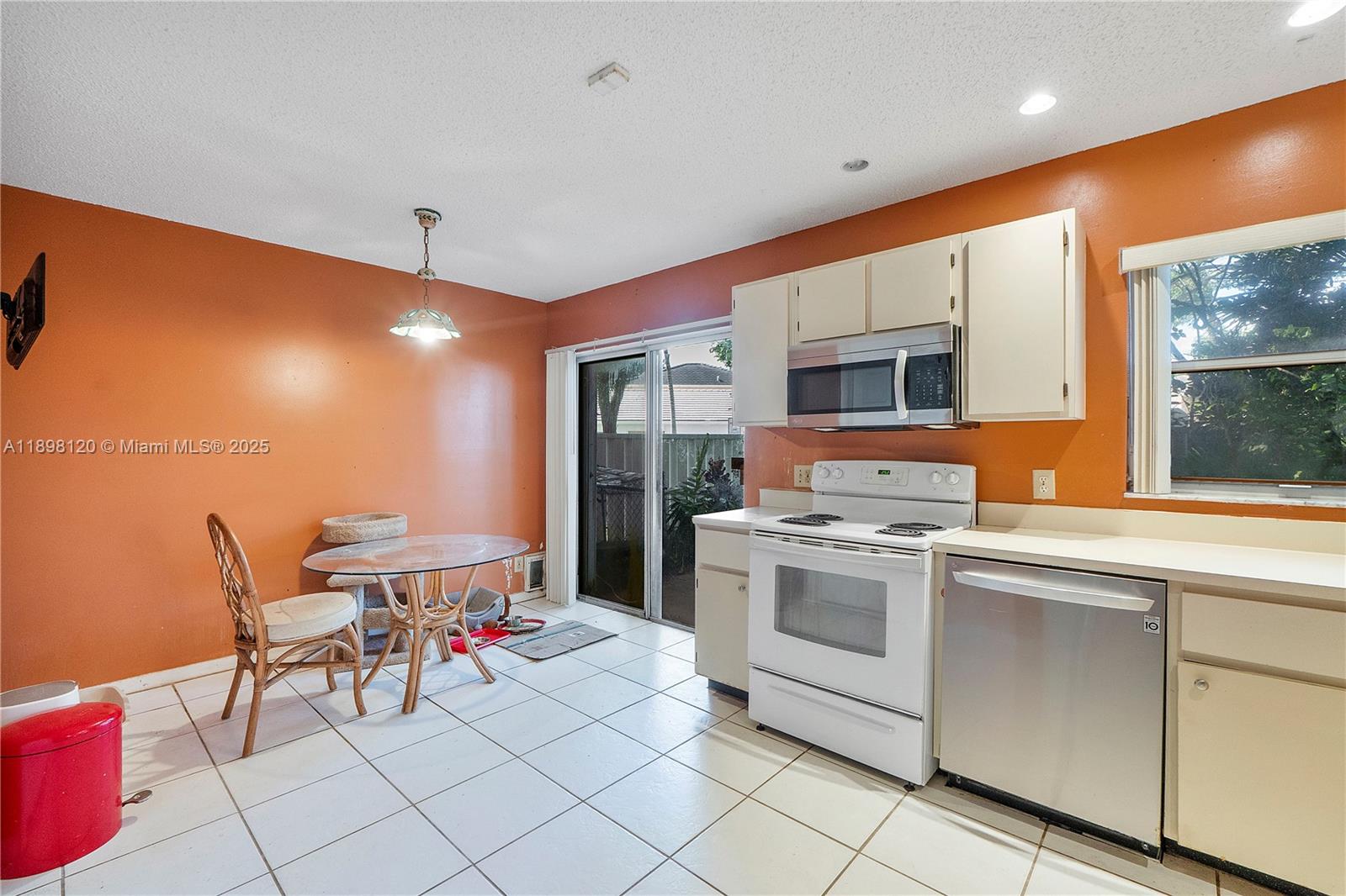 9870 Northwest 2nd Street Plantation, FL 33324 - Photo 4 of 12 a kitchen with a sink and chairs