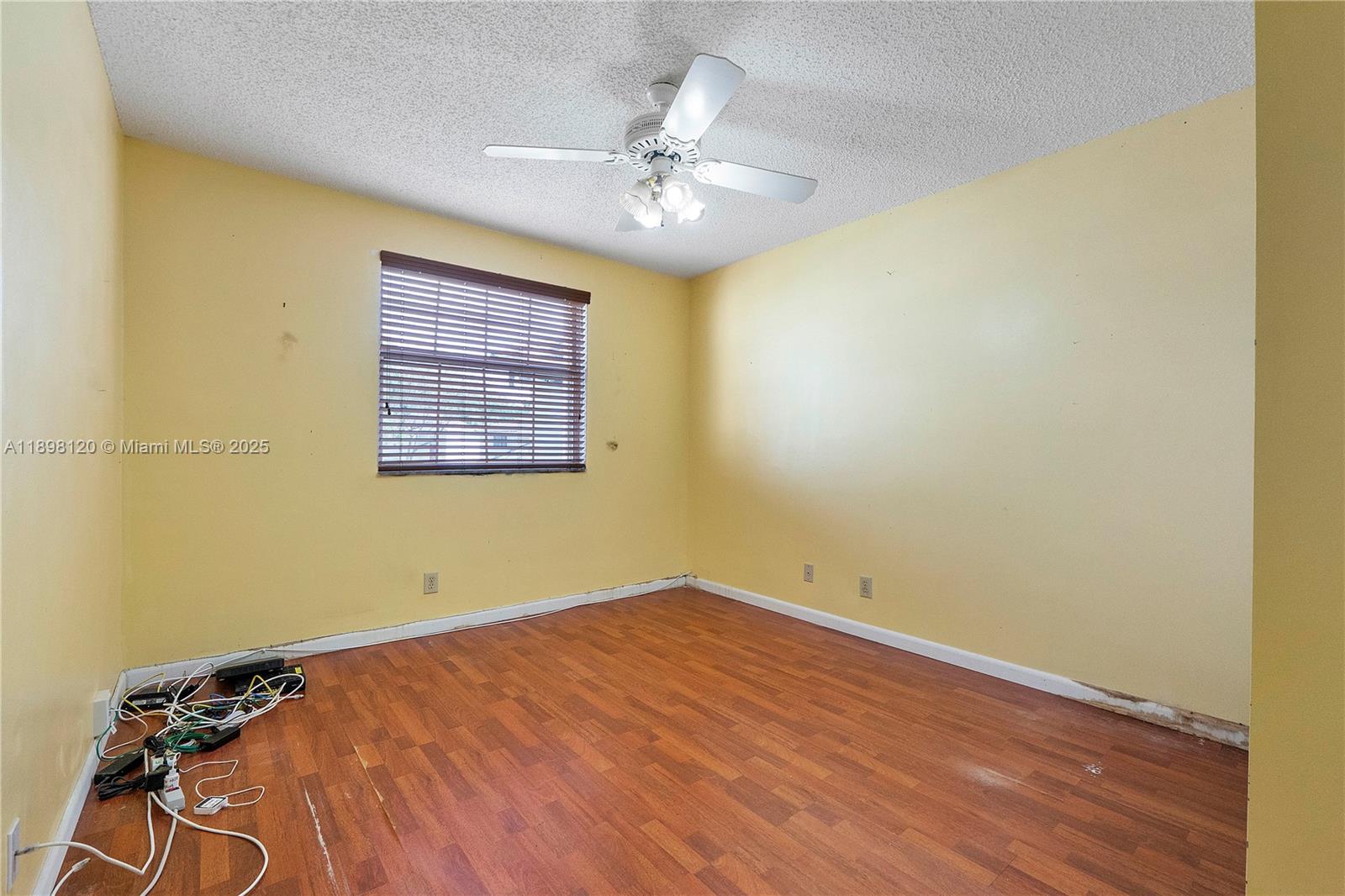 9870 Northwest 2nd Street Plantation, FL 33324 - Photo 9 of 12 a view of a room with a window and a ceiling fan